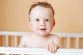 Lovely baby age of 10 months in white bed Royalty Free Stock Photo