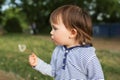 Lovely baby blowing on blowball Royalty Free Stock Photo