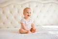 Lovely baby boy in white sunny bedroom Royalty Free Stock Photo