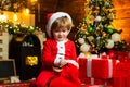 Lovely baby enjoy christmas. Child at Christmas tree and fireplace on Xmas eve. Family with kids celebrating Christmas Royalty Free Stock Photo