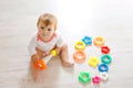 Lovely baby girl playing with educational toys in nursery. Happy healthy child having fun with colorful different toys Royalty Free Stock Photo