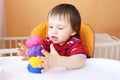 Lovely baby with plasticine at home