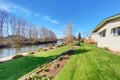 Lovely back yard with grass and river. Royalty Free Stock Photo