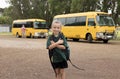 Beautiful blond Caucasian female child waiting for school bus carrying backpack smiling happy in student young girl and schoolgirl