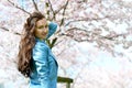 Lovely Beautiful Caucasian Woman Standing Posing on the Background of Blooming Japan Cherry Royalty Free Stock Photo
