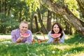 Lovely beautiful couple eating watermelon and lying on the grass Royalty Free Stock Photo