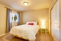 Lovely bedroom interior with beige walls and nice curtains.