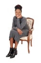 Lovely black female sitting in an old arm chair Royalty Free Stock Photo