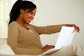 Lovely black woman smiling and looking to laptop