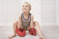 Lovely blond boy in red boxing gloves. Sports concept Royalty Free Stock Photo