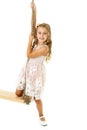 Lovely blonde girl hanging on rope swing Royalty Free Stock Photo