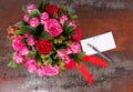 Lovely bouquet of pink roses with gift tag and red ribbon in a c Royalty Free Stock Photo
