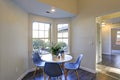 Lovely breakfast nook with white round table and blue chairs. Royalty Free Stock Photo