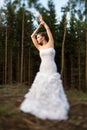 Lovely bride on her wedding day outdoors in a forest