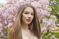 Lovely brunette woman portrait. Beautiful female model with long hair and make-up in spring garden outdoor Royalty Free Stock Photo