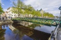 Lovely calming cityscape view. Cute bridge over small river decorated with flowers.