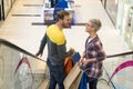 Lovely Caucasian couple doing shopping in a shopping centre Royalty Free Stock Photo