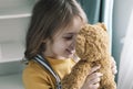 Lovely caucasian girl holding teddy bear,child with toy,smiling happy kid portrait indoors.Happy childhood Royalty Free Stock Photo