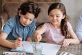 Lovely cheerful kids painting a watercolor picture together