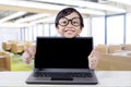 Lovely child with laptop shows thumbs up Royalty Free Stock Photo