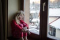 Lovely child looking through window Royalty Free Stock Photo