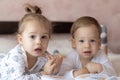 Lovely children - brother and sister, reading a book, on the bed. Close up of children in bed reading a book. A boy and Royalty Free Stock Photo