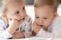 Lovely children - brother and sister, reading a book, on the bed. Close up of children in bed reading a book. A boy and Royalty Free Stock Photo