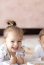 Lovely children - brother and sister, reading a book, on the bed. Close up of children in bed reading a book. A boy and Royalty Free Stock Photo