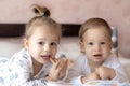 Lovely children - brother and sister, reading a book, on the bed. Close up of children in bed reading a book. A boy and Royalty Free Stock Photo