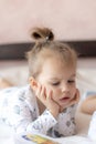 Lovely children - brother and sister, reading a book, on the bed. Close up of children in bed reading a book. A boy and Royalty Free Stock Photo