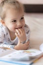 Lovely children - brother and sister, reading a book, on the bed. Close up of children in bed reading a book. A boy and Royalty Free Stock Photo