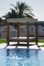 Lovely close-up of a beach sunbath shelter with sparkling water surface in the bottom of the image Royalty Free Stock Photo