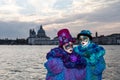 Lovely colored couple at sunset during venice carnival Royalty Free Stock Photo
