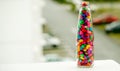 Lovely colorful small pebbles with  in a clear glass bottle Royalty Free Stock Photo