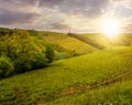 Lovely countryside with grassy hills at sunset