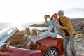 Lovely couple on the beach, traveling by car Royalty Free Stock Photo