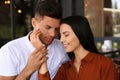 Lovely couple with beautiful ring after engagement in outdoor cafe Royalty Free Stock Photo