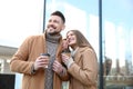 Lovely couple with cups of coffee on street in morning Royalty Free Stock Photo