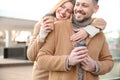 Lovely couple with cups of coffee on street in morning Royalty Free Stock Photo