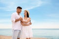 Lovely couple dancing on beach near sea. Space for text Royalty Free Stock Photo