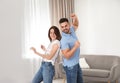 Lovely couple dancing together at home