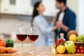 Lovely couple drinking wine in kitchen at their home