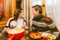 Lovely couple eating traditional swiss cheese fondue Royalty Free Stock Photo