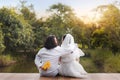 Lovely couple groom hug bride and hide flower behind him at beautiful time