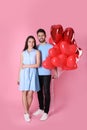 Lovely couple with heart shaped balloons on background. Valentine`s day celebration Royalty Free Stock Photo