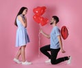 Lovely couple with heart shaped balloons on background. Valentine`s day celebration Royalty Free Stock Photo