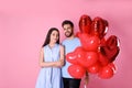 Lovely couple with heart shaped balloons on background. Valentine`s day celebration Royalty Free Stock Photo