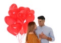 Lovely couple with heart shaped balloons on white background. Valentine`s day celebration Royalty Free Stock Photo