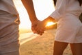 Lovely couple holding hands on beach at sunset, closeup Royalty Free Stock Photo