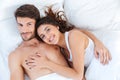 Lovely couple hugging on their bed at home Royalty Free Stock Photo